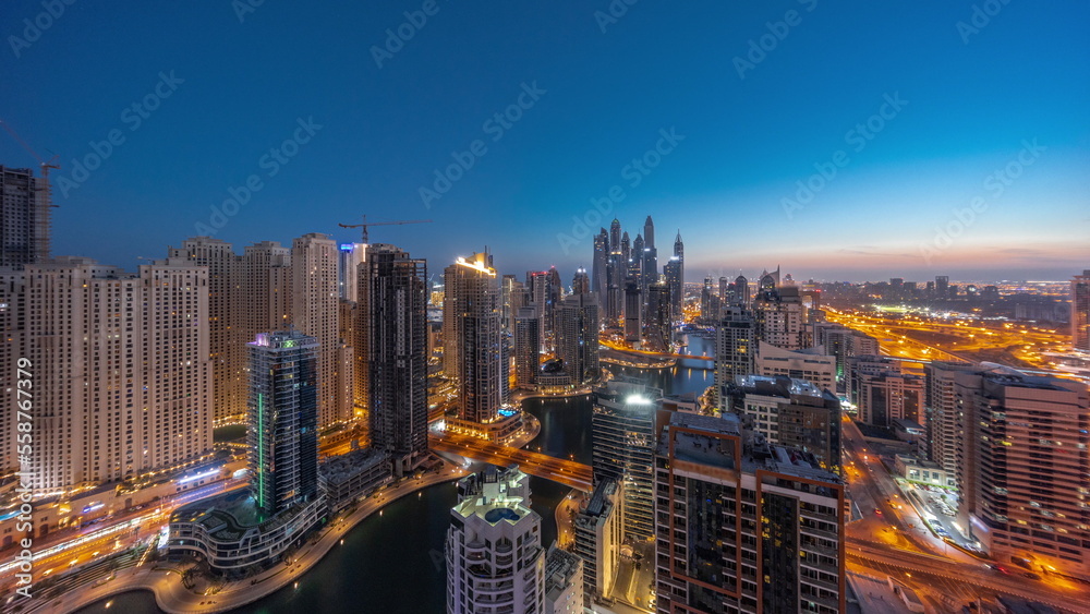Panorama of various skyscrapers in tallest recidential block in Dubai Marina aerial night to day timelapse