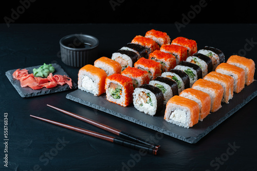 Different sushi rolls on a black background