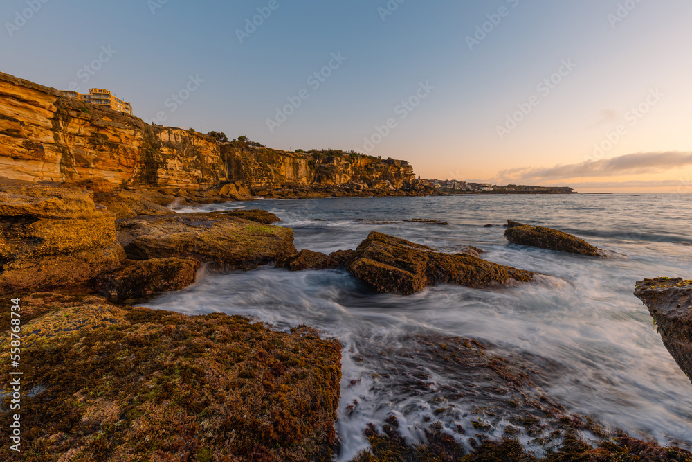 Flowing water on the bottom of ocean cliff.