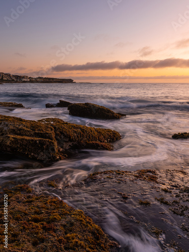 Water flowing between rocks on the coast.