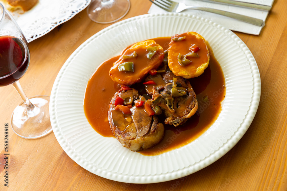 Roasted mutton served with vegetable gravy and baked potato