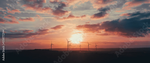 silhouette of wind turbines at sunset under the big sky