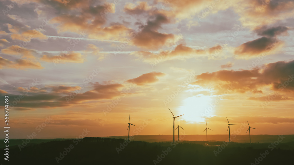 silhouette of wind turbines at sunset under the big sky
