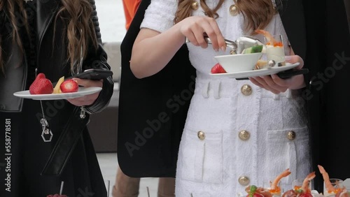 Cheese plate. Woman's hand taking slice of cheese. Wine appetizer set