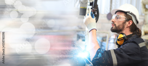 engineer checking robot welding machine