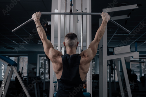 guy exercise in the gym with dumbbells, sports nutrition