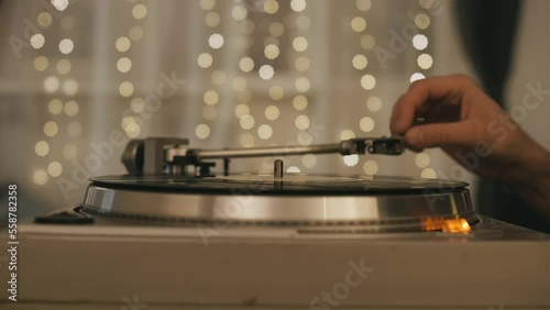 Vintage vinyl record close-up. Retro music player on living room home background with evening light photo