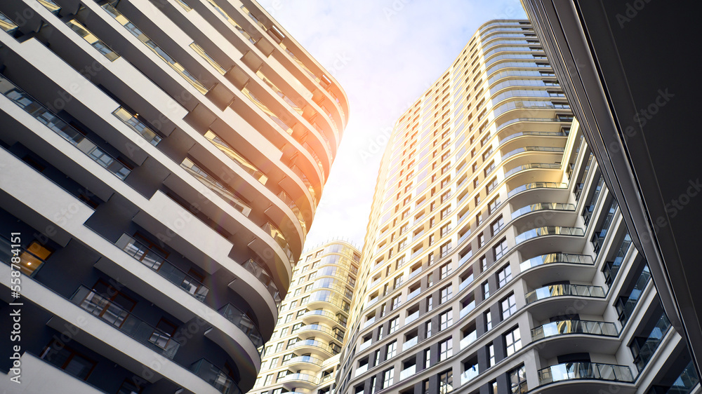 The narrow passage between modern residential buildings. Walls of high