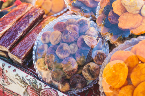 View of traditional armenian local candy sweets delights with churchkhela, sweet sausage, sudzhuk, dried fruits, walnuts and others for sale in a local vendor souvenir shop kiosk of Yerevan, Armenia photo