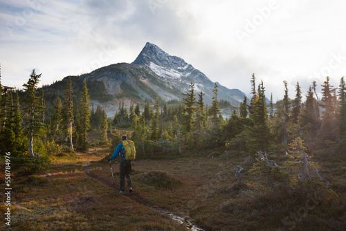 Man with backpack hiking to Jim Kelly Peak photo