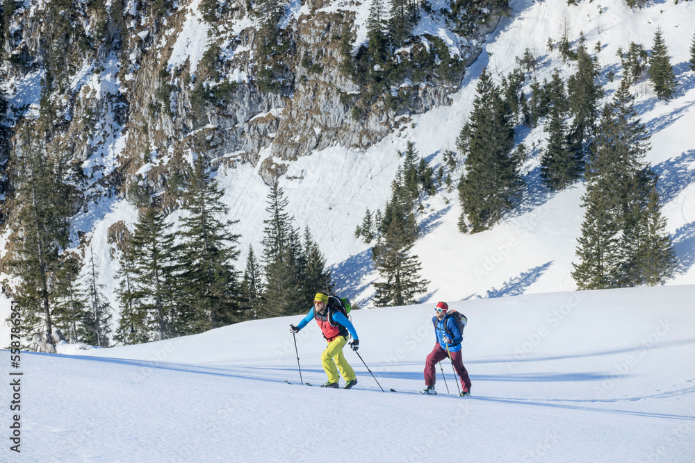 Skiers climbing on snowcapped mountain Skiers climbing on snowcapped mountain
