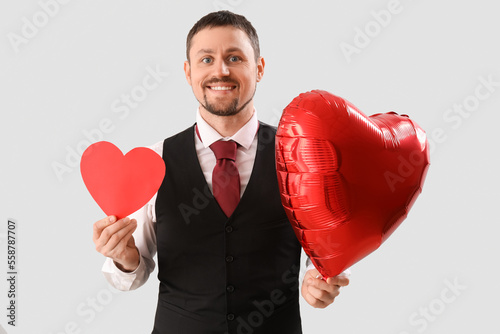 Smiling man in vest and tie...
