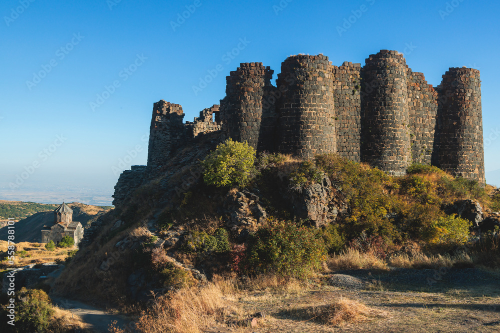 Beautiful sunny view of Amberd fortress, Mount Aragats with horse pasturing, Aragatsotn, Armenia in a summer day Beautiful sunny view of Amberd fortress, Mount Aragats with horse pasturing, Aragatsotn, Armenia in a summer day