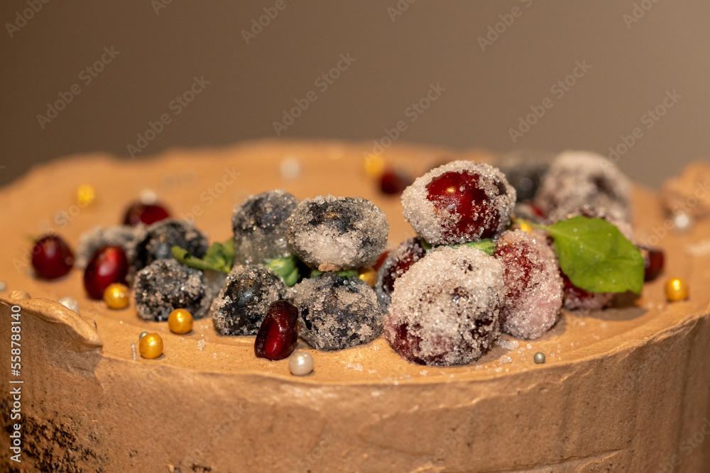 A chocolate whipped frosted cake with maceration berries. The delicious