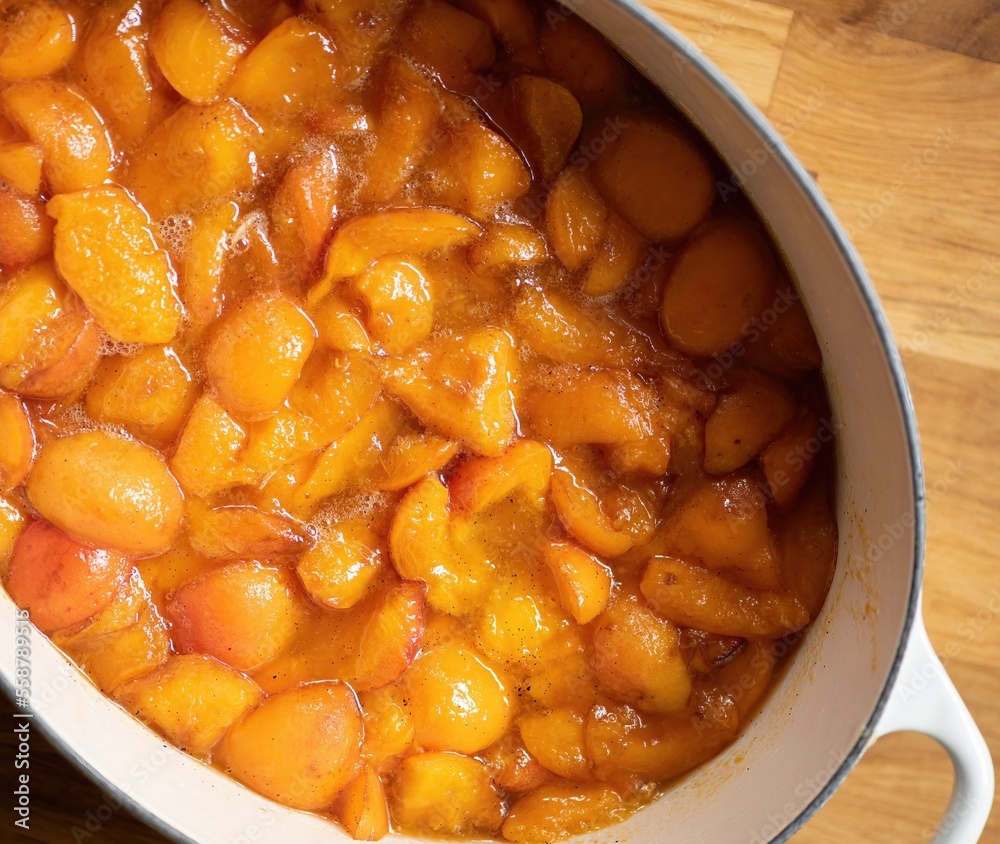 Fresh apricots in syrup with vanilla seeds ready to be cooked into apricot jam. Fresh apricots in syrup with vanilla seeds ready to be cooked into apricot jam.