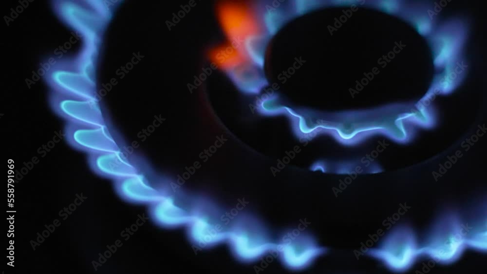 Ignite gas stove top in slow motion, Top Side view Closeup Ignite gas stove top in slow motion, Top Side view Closeup