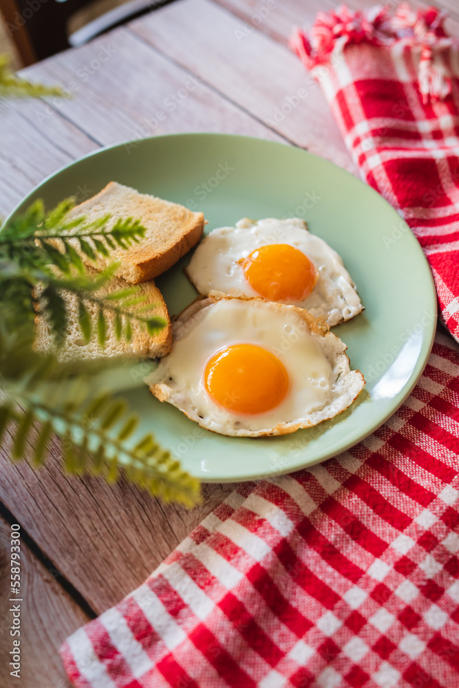 A top down and side view of eggs on the plate with toast bread on the side for breakfast clean meal healthy food A top down and side view of eggs on the plate with toast bread on the side for breakfast clean meal healthy food