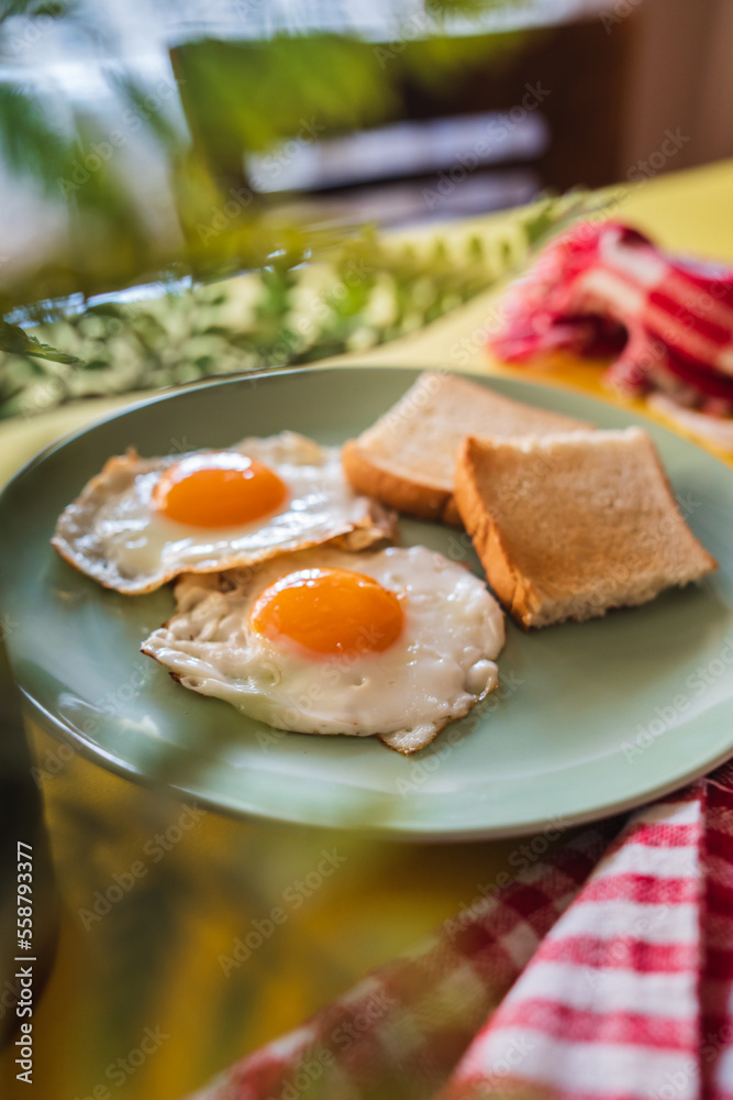 Fototapeta premium A top down and side view of eggs on the plate with toast bread on the side for breakfast clean meal healthy food 