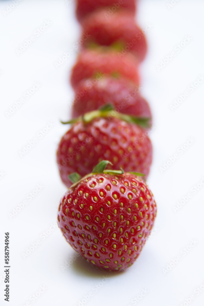 Raw of juicy strawberries on a white background Raw of juicy strawberries on a white background