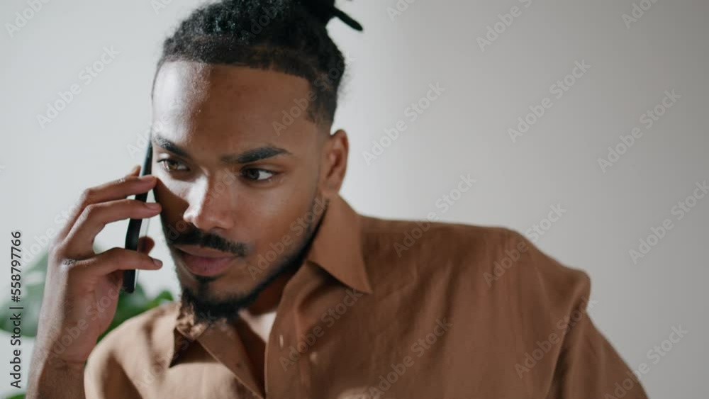 Confident businessman answering call home closeup. Dreadlocks guy talking mobile Confident businessman answering call home closeup. Dreadlocks guy talking mobile