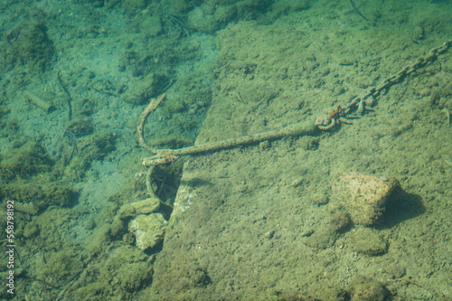 Photo of an anchor and chain underwater near the fishing village of Naoussa on the Greek island of Paros.