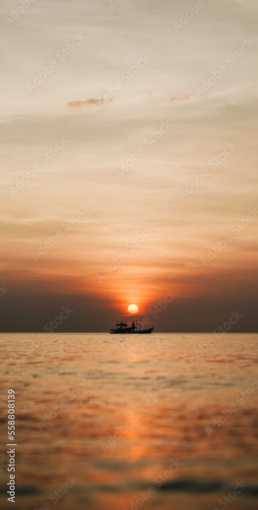 Sunset at sea and with ships in the sea.
