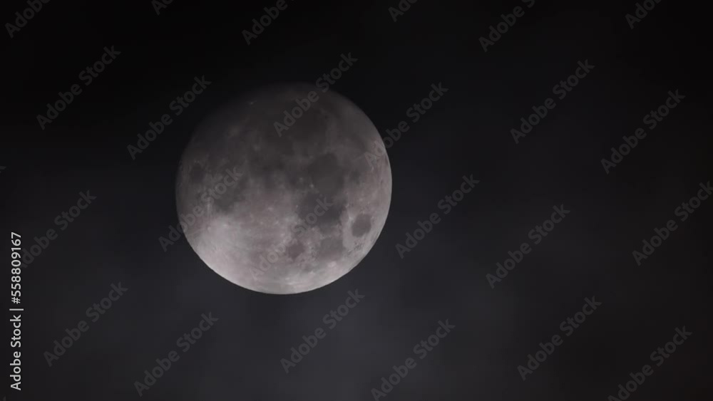 Moon flying through dense dark clouds at night. Big full moon phase time lapse in black clouds running. Halloween witchcraft, Atmospheric dark night sky with moon for mystic thriller mood concept. Moon flying through dense dark clouds at night. Big full moon phase time lapse in black clouds running. Halloween witchcraft, Atmospheric dark night sky with moon for mystic thriller mood concept.