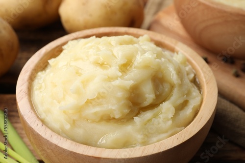 Bowls of tasty mashed potato on wooden table, closeup