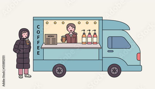 korean street food. Koreans who drink iced coffee even in the cold winter. A customer is wearing a down jacket and ordering an iced americano from a coffee truck.