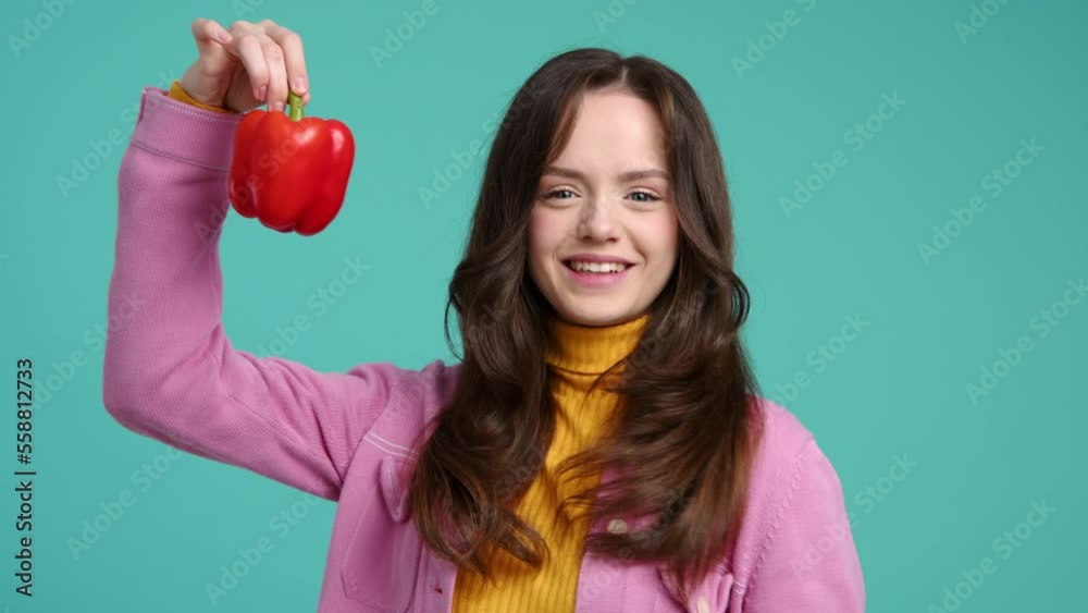 Close-up shot of female vegetarian smelling flavorous bell pepper. Portrait of a cheerful, brunette-haired woman holding fresh, raw food. High quality 4k footage Close-up shot of female vegetarian smelling flavorous bell pepper. Portrait of a cheerful, brunette-haired woman holding fresh, raw food. High quality 4k footage