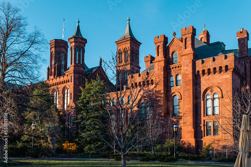 Sunny day shot of the side view of the Smithsonian Castle. It houses the Smithsonian Institution’s administrative offices and information center.  photo