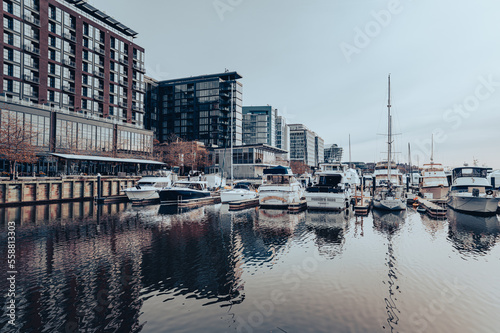 The Wharf reestablished Washington, DC, as a waterfront city and destination. Cloudy day at the marina, where boats are parked. Buildings in the back. © Michael