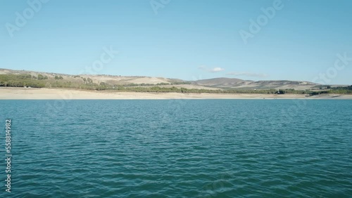 Drone shot quickly flying over the Los Bermejales Reservoir in Spain.