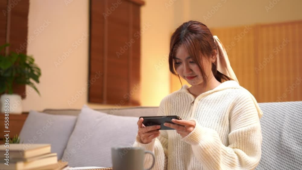 Winter season concept, Young woman playing video games on smartphone in night time at winter Winter season concept, Young woman playing video games on smartphone in night time at winter