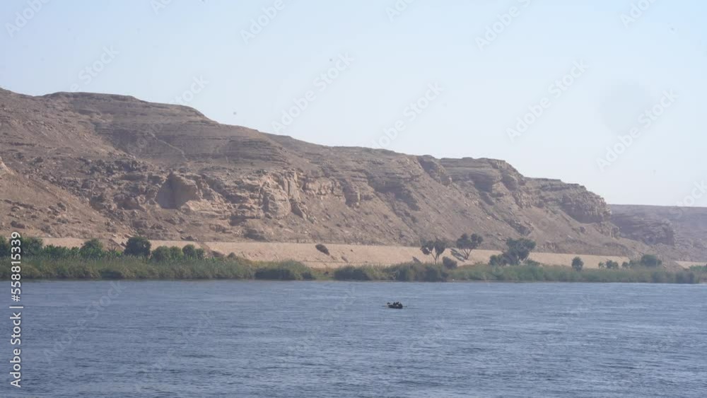 Rowing Boat in the Nile with Desert Dune Backdrop Rowing Boat in the Nile with Desert Dune Backdrop