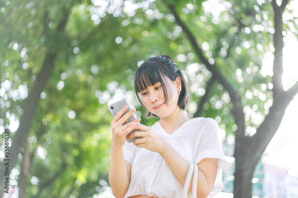 Young adult southeast asian business single woman using smartphone talking with friend happy face and laugh Young adult southeast asian business single woman using smartphone talking with friend happy face and laugh