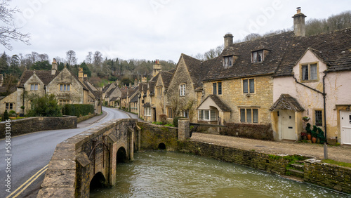 Castle Combe , Beautiful village in Cotwolds with old stone houses bridge and river during winter in Wiltshire , United Kingdom : 6 March 2018 photo