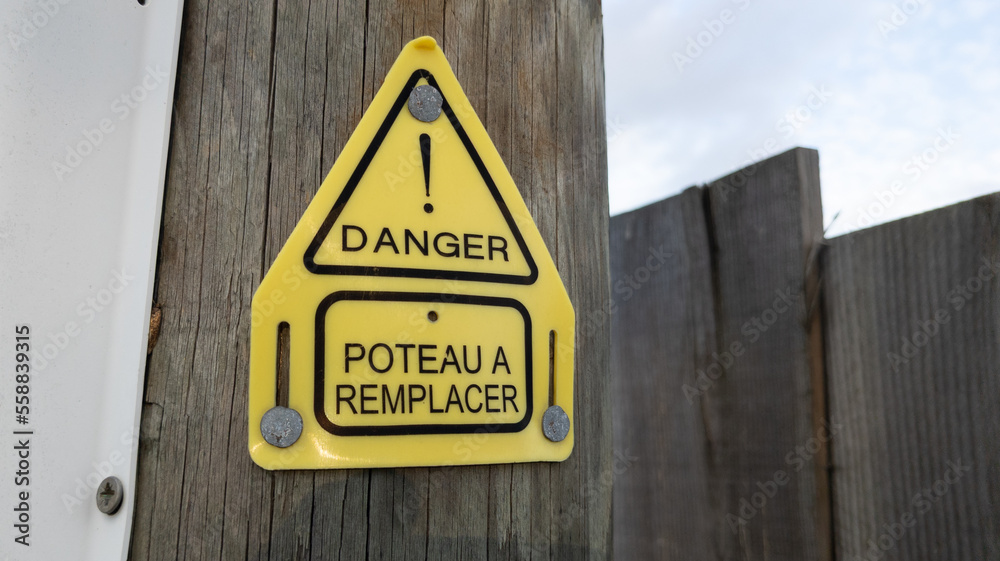 danger poteau a remplacer sign text french means danger and pole to be replaced in wooden telephone electric pole danger poteau a remplacer sign text french means danger and pole to be replaced in wooden telephone electric pole