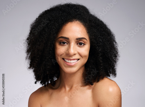 Beauty, portrait and skincare with a model black woman in studio on a gray background for natural skin cosmetics. Face, hair and afro with an attractive young female posing to promote skin treatment