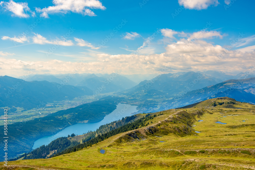 Panoramic view of Drava river valley, Lake Millstatt and small ponds known as the eyes of Mirnock on top of Mount Mirnock 2,110 m., Nock Mountains, Gurktal Alps, Austria.