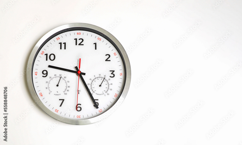 Classic clock on a white wall. Humidity and temperature. Copy space. Classic clock on a white wall. Humidity and temperature. Copy space.