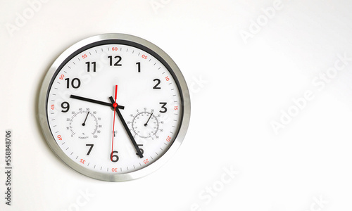 Classic clock on a white wall. Humidity and temperature. Copy space.