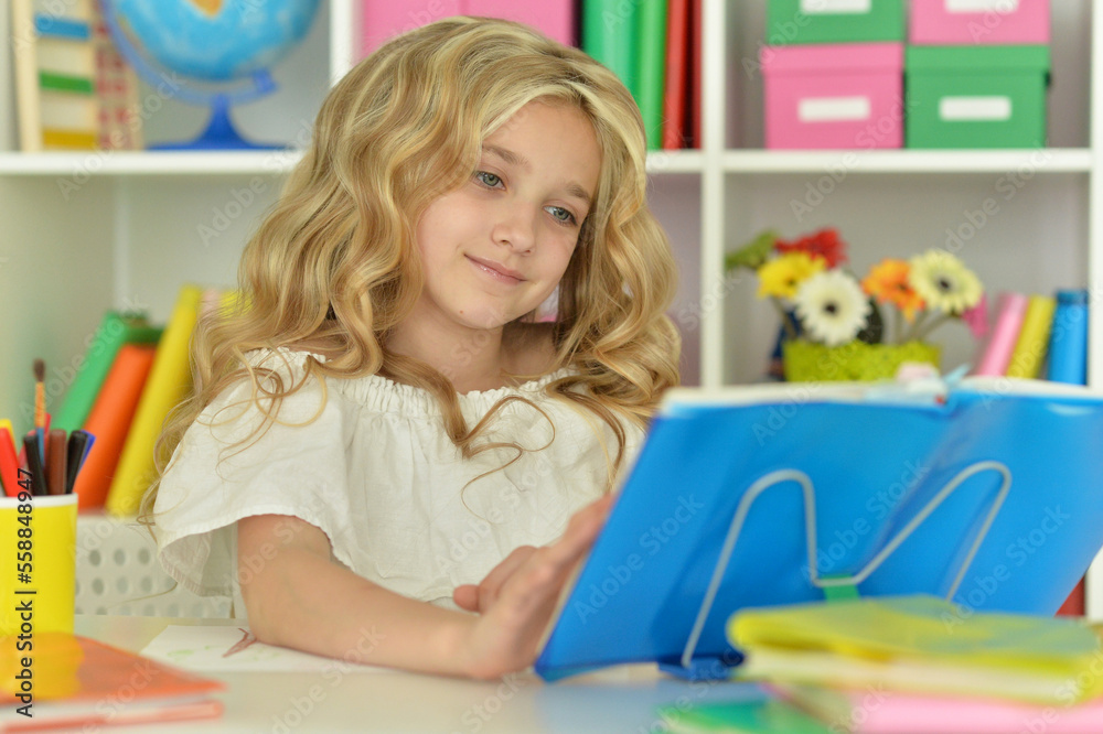 little girl studying at home at the table little girl studying at home at the table
