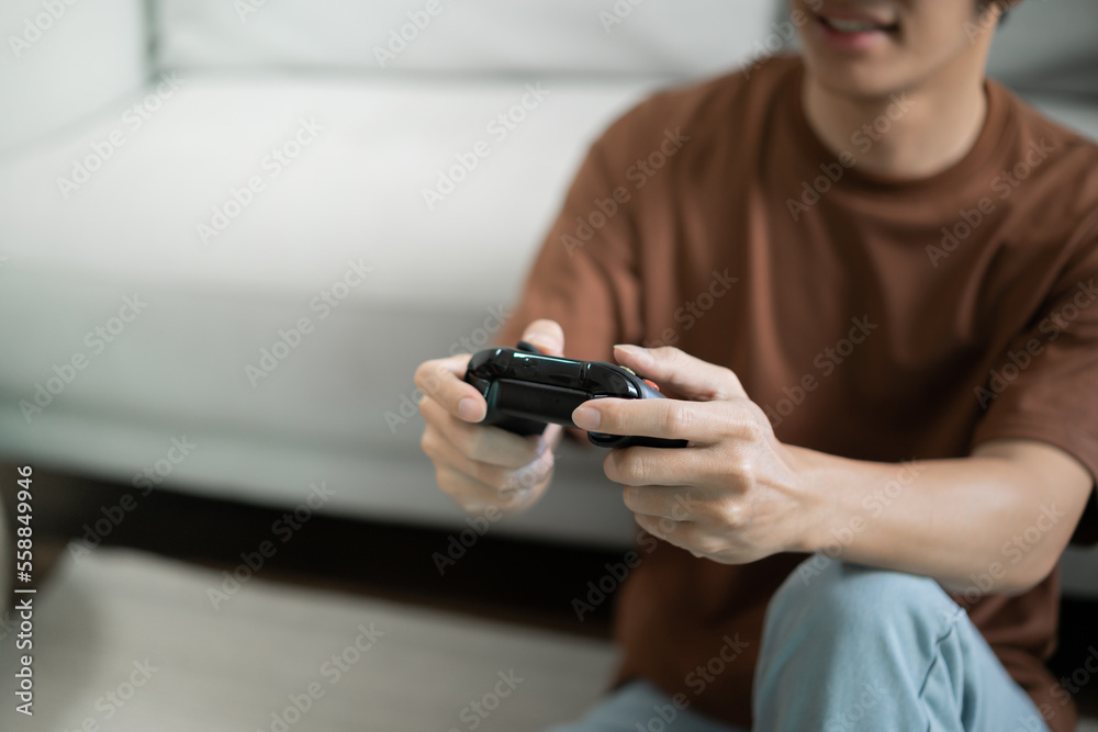 Young Asian man gamer controller video console playing holding hobby playful Online Video Game enjoyment eSport Cyber Games Internet. Young Asian man gamer controller video console playing holding hobby playful Online Video Game enjoyment eSport Cyber Games Internet.