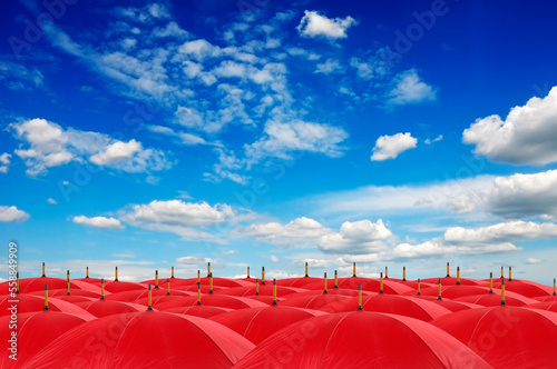 Red umbrellas and blue sky above