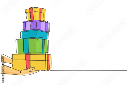 Single one line drawing woman hands gives gift in boxes. Girl holding huge stack New Year presents. Millennial female carrying pile of wrapped gifts box. Continuous line draw design graphic vector