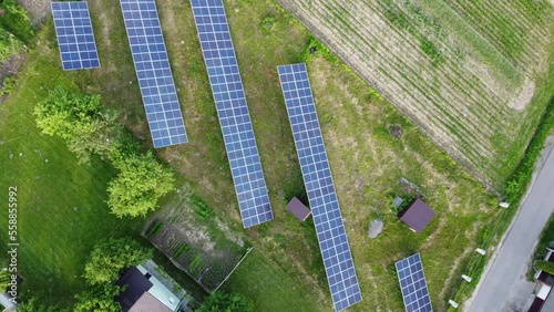 Aerial view of solar power plant on green field. Electric panels for producing clean ecologic energy.