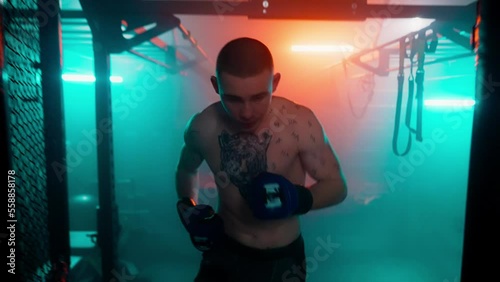 MMA fighters enter the cage ring. Mixed martial arts fight. Cinematic staged fight. Boxing in a ring or cage. Two fighters fight for the right to be the champion.
Boxer in the boxing gym. Bandages his photo