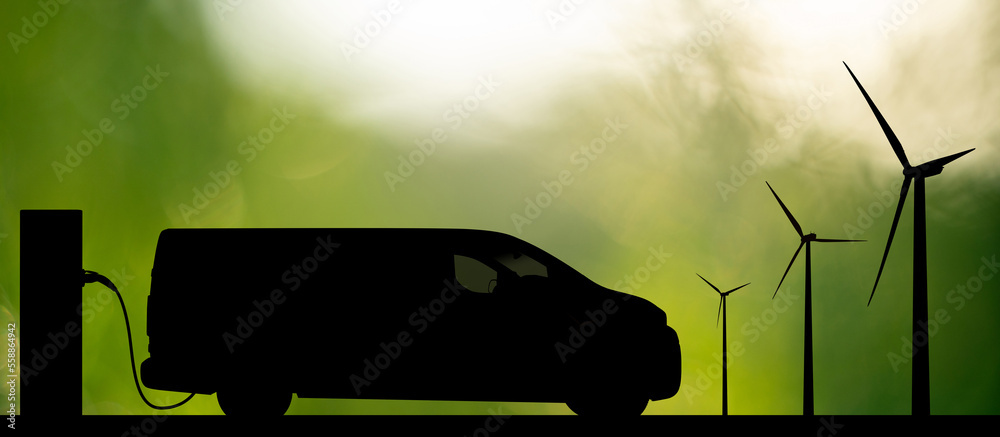 Silhouette of electric van with charging station and wind turbines on a green background
