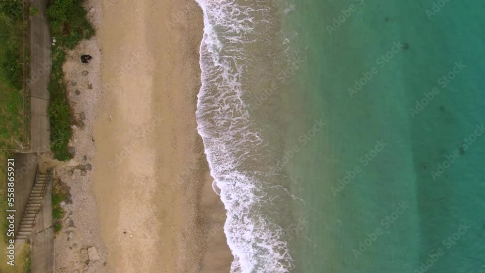 Gentle waves crashing onto pristine Amami beach, Japan - aerial top down Gentle waves crashing onto pristine Amami beach, Japan - aerial top down